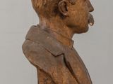 statue of a man with a pipe in his mouth sitting on a table