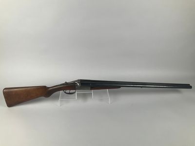 a shotgun with a wooden barrel and a wooden handle