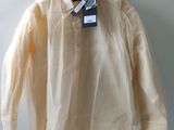 a white shirt hanging on a hanger on a wall