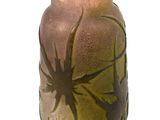 a glass vase with a spider on it on a stand