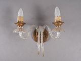 une paire d'appliques en cristal et en laiton sur un mur blanc