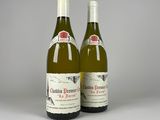 two bottles of wine sitting next to each other on a table