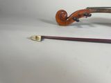 a violin and a violin stick on a white surface