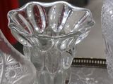 several glass vases are sitting on a metal tray in a store