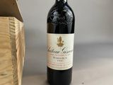 a bottle of wine sitting next to a wooden box