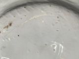 a white plate with a number on it on a table