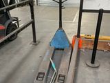 a fork lifter sitting in the middle of a warehouse