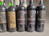 several bottles of wine are lined up on a table