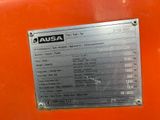 a close up of a metal plate on a orange machine