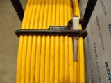 a close up of a yellow hose on a cart