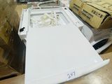 an image of a white washing machine in a warehouse