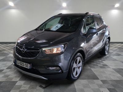the grey buick suv is parked on a checkered floor