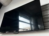 a flat screen tv mounted on a wall in a room