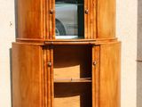 a wooden cabinet with a glass door in front of a building