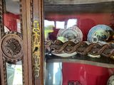 a glass display case with a lot of decorative items on it