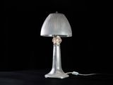 a lamp that is sitting on a table with a black background