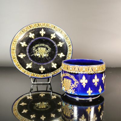 pair of royal blue and gold cups and saucers on a black table