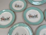 six blue and white plates with a picture of a horse drawn carriage on them