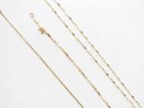 three gold chain necklaces on a white background