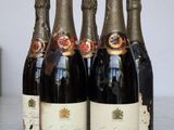 four bottles of wine are lined up on a table