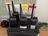 several walkie talkies are in a charging station on a desk