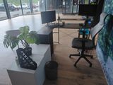 a desk with a chair and a computer on it