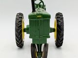 a toy tractor that is sitting on a white surface