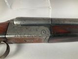 a close up of a gun on a white surface