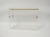 a clear acrylic magazine holder with gold handles
