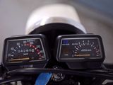 two speedometers on the handlebars of a motorcycle