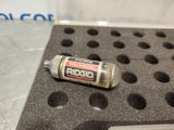 a bottle of riddo sitting on top of a piece of black foam
