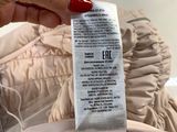 the label on the jacket is telling the price of the jacket