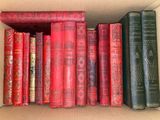 a box full of old books on a shelf