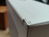 a white refrigerator sitting on top of a wooden table