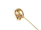 broche en or jaune ornée d'un fer à cheval et d'un diamant