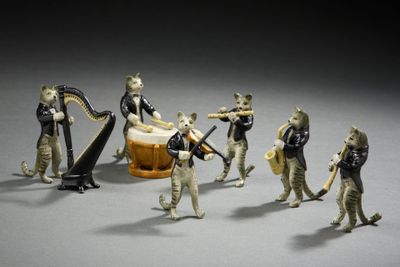 many figurines of people playing musical instruments together