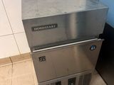 a stainless steel dishwasher sitting on top of a tiled floor