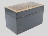 a black box with a decorative design on the lid