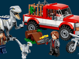 four lego dinosaurs and a truck with a man on it
