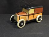 a toy car that is sitting on a black surface