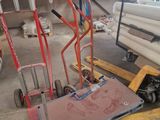 a hand truck with a cart on it in a warehouse