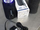 a box with a speaker and a charger on a table