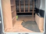 the back of a van with the door open and the back of the van with the back door open