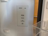 an image of a refrigerator in a kitchen with the door open