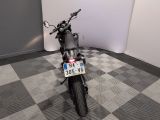 a motorcycle that is parked on a checkered floor
