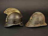 pair of antique helmets on a black background with a black background