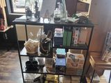 a black shelf with various items on it in a room