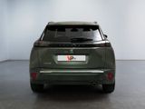 the rear end of a green car in a white room