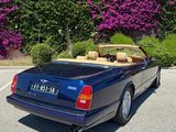 an image of a blue convertible car parked in a parking lot