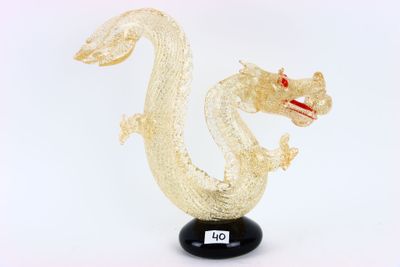 a glass sculpture of a dragon on a black base